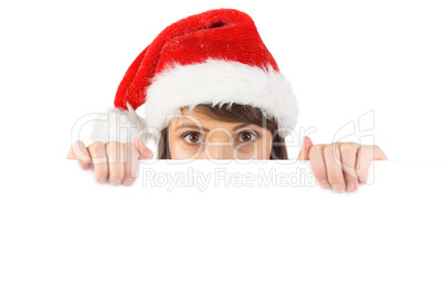 Festive brunette holding a poster