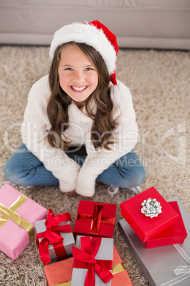 Festive little girl smiling at camera with gifts