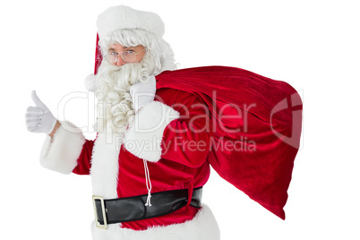 Positive santa with his sack and thumbs up