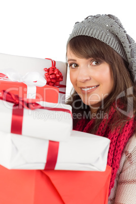 Portrait of a pretty woman holding pile of gifts