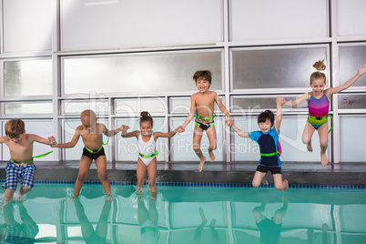 Cute swimming class jumping in the pool