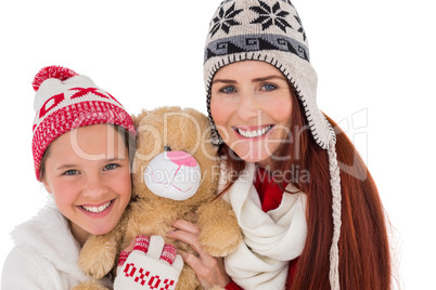 Mother and daughter holding teddy bear