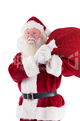 Santa carries his red bag and smiles