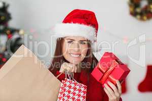 Festive redhead holding christmas gifts