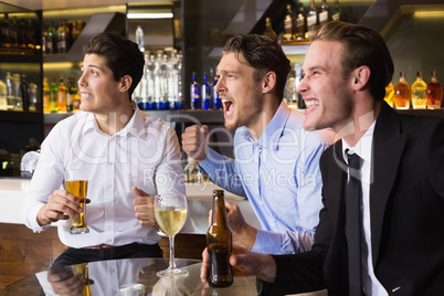 Handsome friends having a drink together