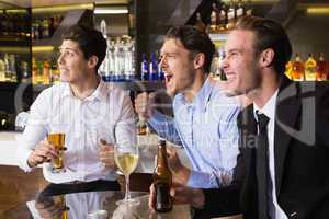 Handsome friends having a drink together