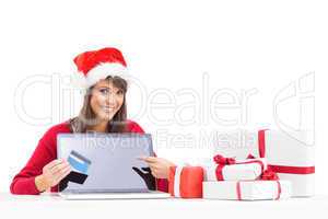 Festive brunette showing a laptop