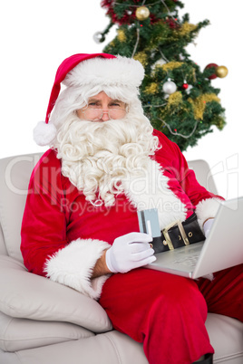 Santa shopping online on the couch