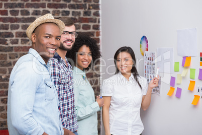 Business team with sticky notes on wall