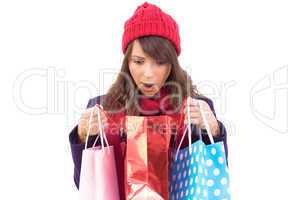 Shocked brunette opening gift bag