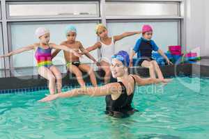 Cute swimming class watching the coach