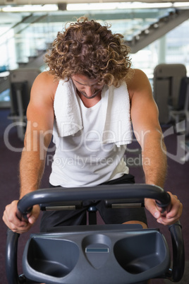 Man working out on exercise bike at gym