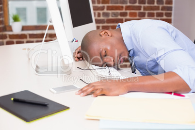 Businessman resting head on computer keyboard