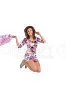 Brunette jumping while holding shopping bags