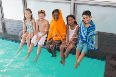 Cute little kids sitting poolside