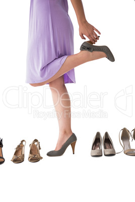 Mid section of woman trying heels