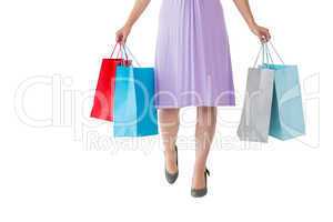 Mid section of woman holding shopping bags