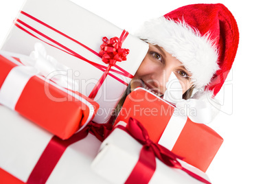 Close up of a festive young woman holding many gifts