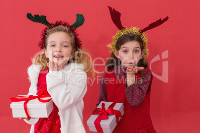 Festive little girls holding gifts