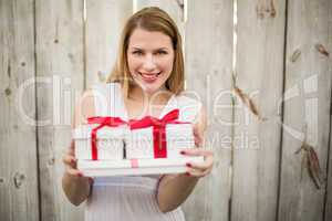 Elegant blonde offering christmas gifts