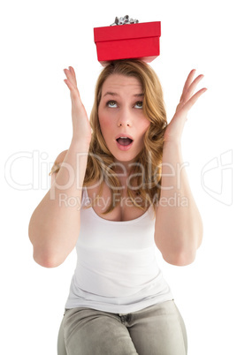 Woman balancing christmas gift on her head