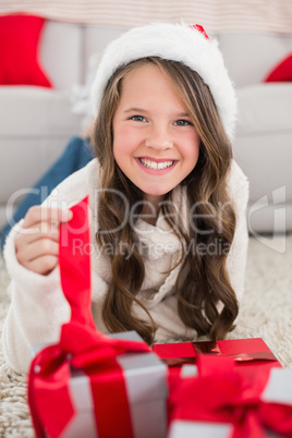 Festive little girl smiling at camera with gifts