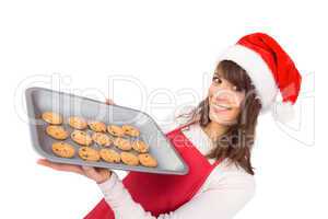 Brunette in santa hat offering hot cookies