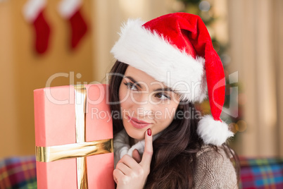 Beauty brunette holding gift at christmas
