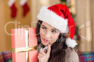 Beauty brunette holding gift at christmas