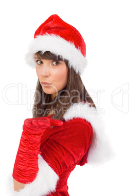 Pretty girl in santa costume holding hand out