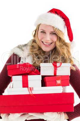 Festive blonde holding pile of gifts