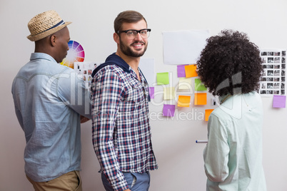 Team looking at sticky notes on wall