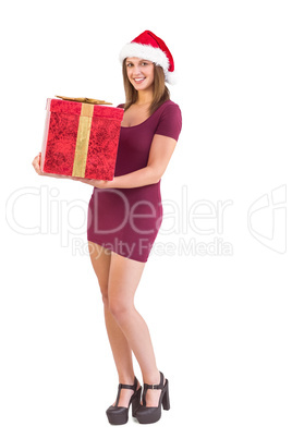 Pretty girl in santa hat holding gift box