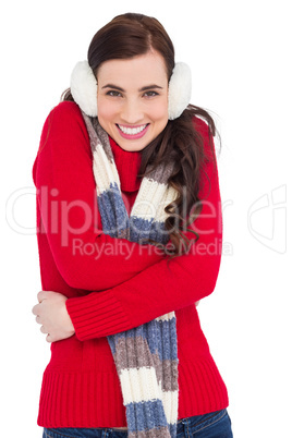 Happy brunette in winter clothes smiling at camera