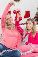 Festive mother and daughter smiling at camera