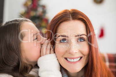 Daughter telling her mother a christmas secret