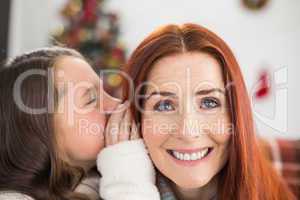 Daughter telling her mother a christmas secret