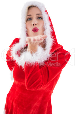 Festive blonde blowing a kiss