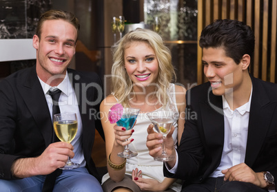 Happy friends having a drink together