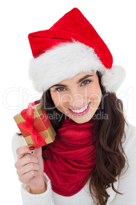 Happy brunette holding christmas gift