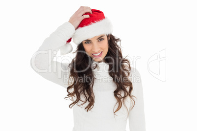 Confused brunette in santa hat