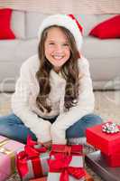 Festive little girl smiling at camera with gifts