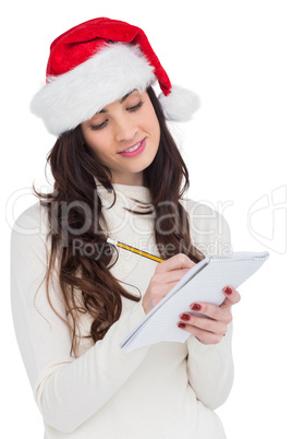 Festive brunette writing her christmas list