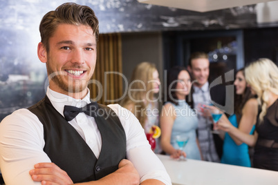 Handsome barman smiling at camera