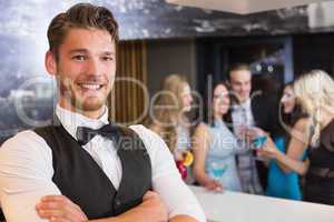 Handsome barman smiling at camera