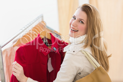 Smiling blonde picking out jacket