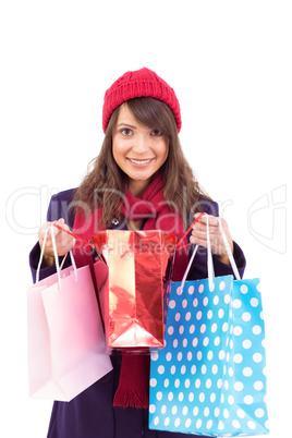 Smiling brunette opening gift bag