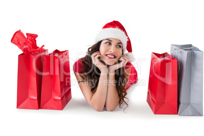 Festive brunette lying with shopping bags