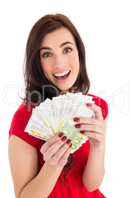 Excited brunette holding her cash