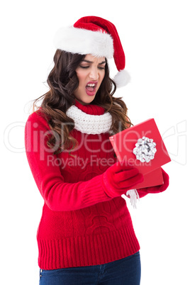 Disappointed brunette opening christmas gift